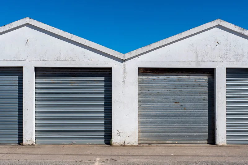 Grey roller doors under twin gables at an industrial estate