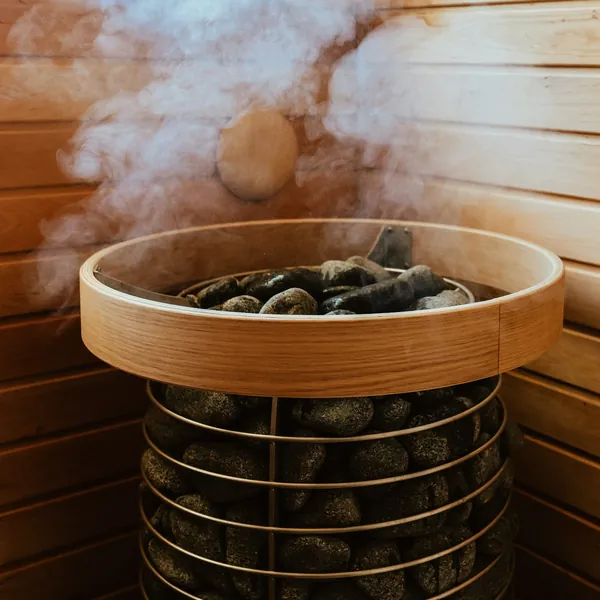Steam rising from the stones of a sauna heater